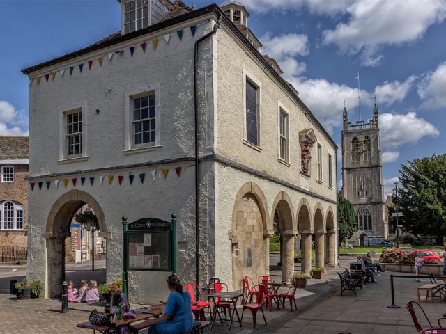 Dursley high street with 18th Century Town and Market Hall and Church of St James in the background, Gloucestershire, United Kingdom