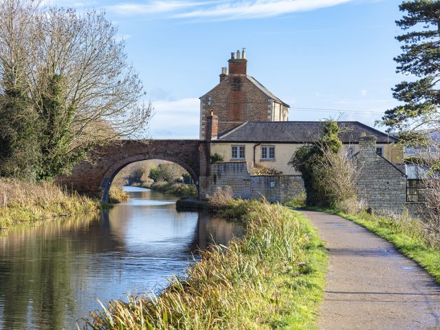 Nutshell Bridge and adjoining house on the Stroudwater Navigation near Stonehouse Stroud, England. The bridge and house were built in 1778 and are Grade II listed.